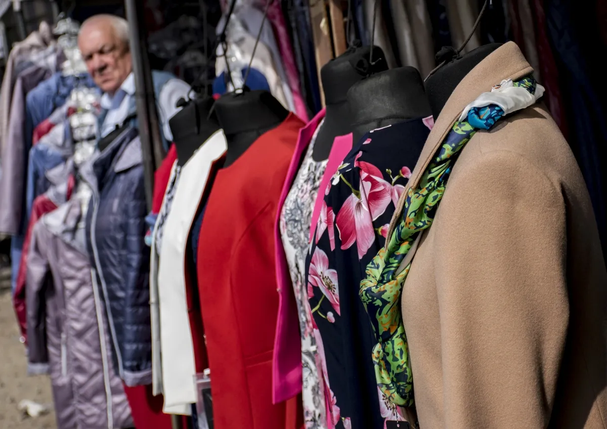 Clothing rack and mannequin torsos at a street market
